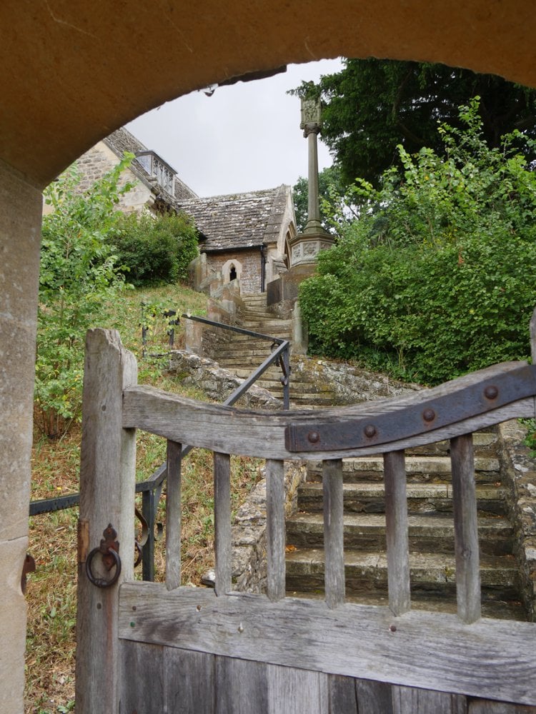 The church gate opens to stone steps winding up to the entrance.